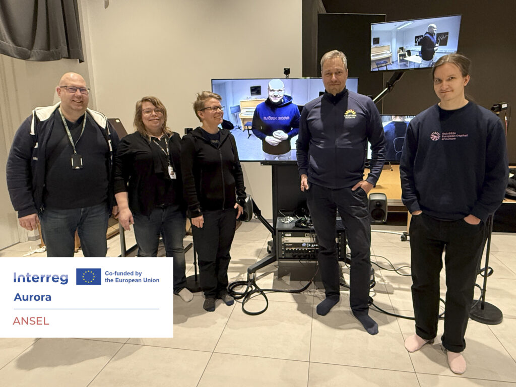 The image shows partners of the ANSEL project at the Kaustinen Music High School, with a view from the Toholampi municipal hall in the background. Photo by Hanna Kenakkala.